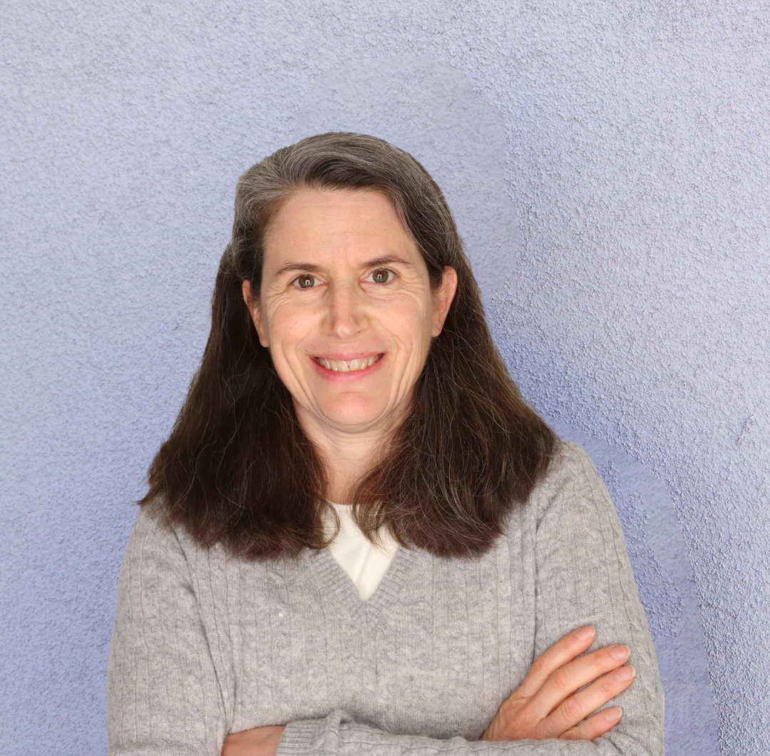 A brunette woman in a gray sweater