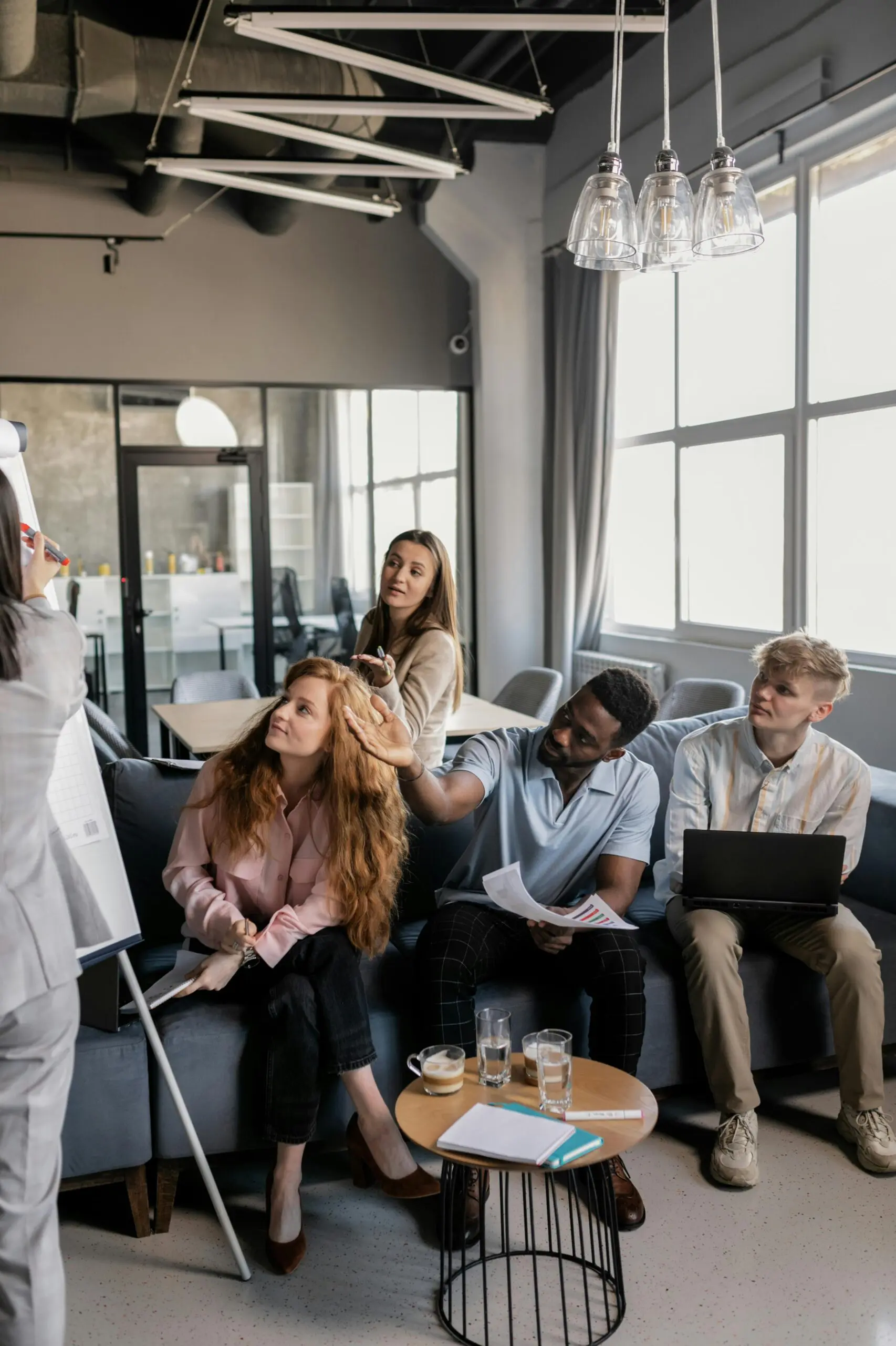 A group of professionals gather to discuss a topic.