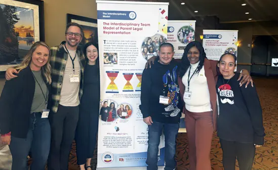 a reunifiied family pictured with their representation team