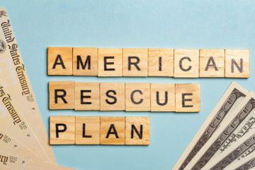 photo of money and government checks with words american rescue plan