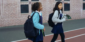 two minority female students walking together at school