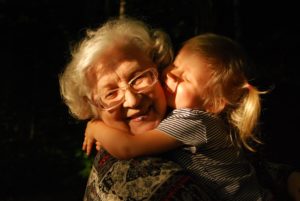 female child hugging grandmother