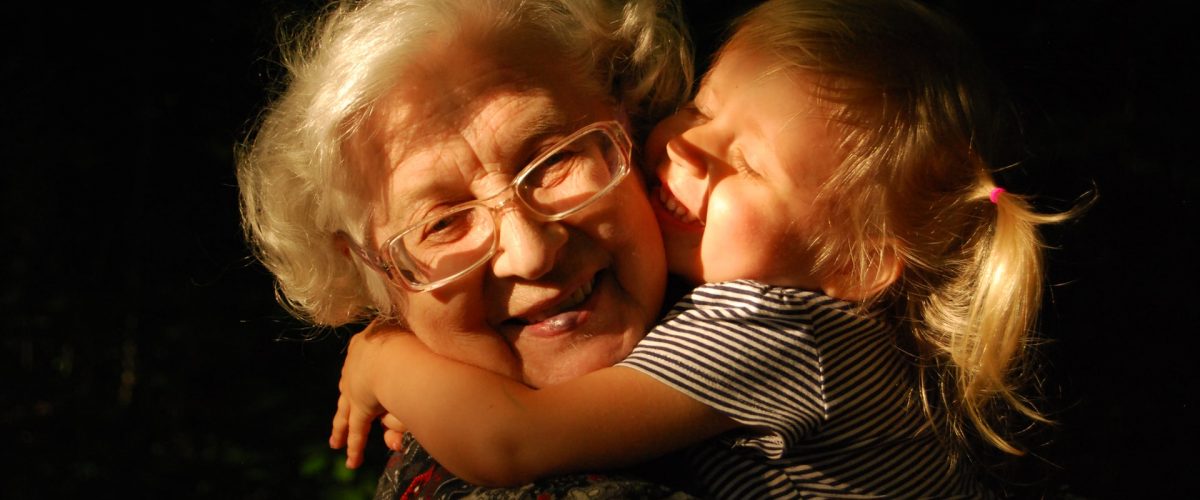 female child hugging grandmother